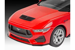 Close-up of the front end of a red 2024 Ford Mustang GT model car showing the hood, grille, and front wheel.