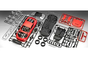 Unassembled plastic model kit parts for a 2024 Ford Mustang GT, including red body panels, black chassis and interior, silver wheels, and clear windows.