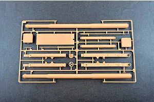 A plastic model kit sprue containing tan-colored parts for an M198 155mm towed howitzer, including long barrel sections and structural components.