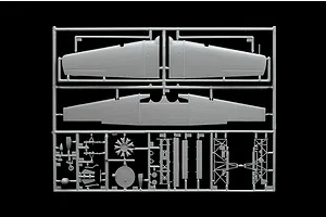 A grey plastic sprue from an Italeri 1/48 scale model aircraft kit, featuring wing sections, engine parts, and landing gear components.