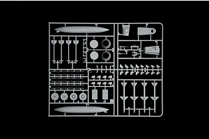 A grey plastic sprue containing various model aircraft parts including missiles, fuel tanks, and landing gear wheels for an F-15C Eagle model kit.