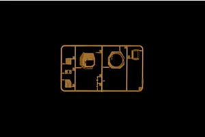 A tan plastic sprue containing various model tank parts, including a turret section, against a solid black background.