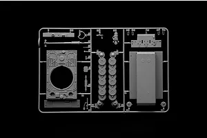 A grey plastic sprue containing various parts for an Italeri 1/56 scale Tiger I tank model kit, including hull, turret, and road wheel components.