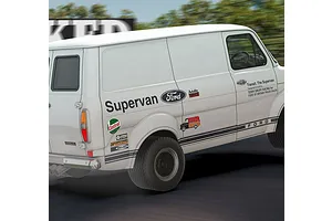 A white Scalextric 1/32 scale Ford Transit Mk 1 Supervan slot car in motion on a track with various racing decals.