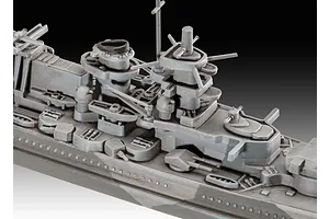 Close-up of the superstructure and deck details of a grey plastic model battleship, showing turrets, masts, and lifeboats.
