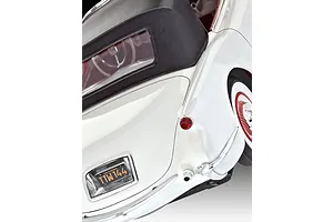 Close-up rear view of a white 1953 Chevrolet Corvette model car showing the black convertible top, taillight, and California license plate.