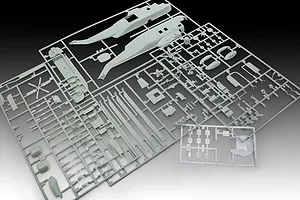 Plastic model kit sprues for a 1/72 scale Westland Sea King helicopter, showing grey fuselage halves, rotor blades, and clear cockpit parts.