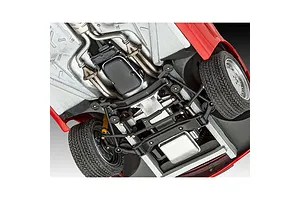 Underside view of a 1/24 scale Revell Mercedes-Benz 300 SL-24 model car showing detailed chassis, suspension, exhaust, and engine components.