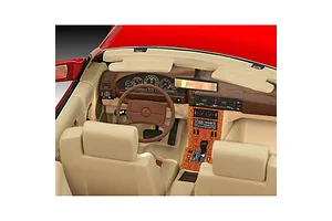 Detailed interior view of a 1/24 scale model Mercedes-Benz 300 SL-24, showing beige seats, a brown dashboard, and wood-grain center console.
