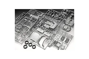 Unassembled plastic model car parts on sprues for a Revell Mercedes-Benz 300 SL-24, including body panels, interior, and four rubber tires.