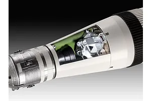 Close-up of a Saturn V model rocket showing the lunar module inside a cutaway section of the third stage.