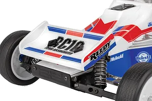 Close-up of the rear wing and suspension of a Team Associated RC10 Sprint RC car, featuring white, red, and blue livery.
