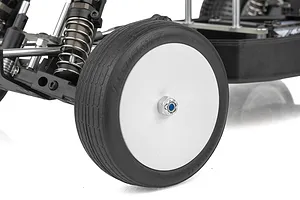 Close-up of the front wheel and suspension of a Team Associated RC10 Sprint RC car, showing a white dish wheel with a black rubber tire.