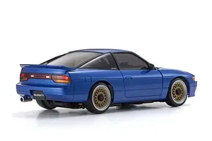 Rear three-quarter view of a blue Kyosho Mini-Z Nissan Sileighty RC drift car with gold mesh wheels on a white background.