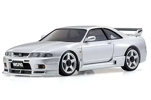 A studio shot of a silver Kyosho Mini-Z Nissan Skyline GT-R NISMO R33 RC drift car on a white background.
