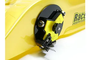 Raceform wheel arch cutter tool mounted on a yellow RC car body shell, showing the adjustable cutting blade and guide bearings.