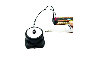 MTTR RC tire gluing tool powered by a LiPo battery, with a hand applying glue to the tire sidewall.