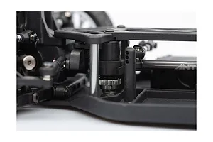Close-up of the chassis and steering assembly of an LRP Antix S10 Blast RC buggy, showing black plastic components and metal hardware.