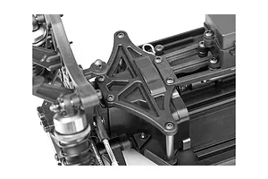 Close-up of the black plastic chassis and suspension tower assembly of an LRP S10 Blast RC buggy.