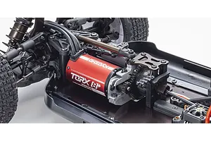 Close-up of the Kyosho Torx 8+ brushless motor installed in the chassis of a Kyosho Inferno MP10e RC buggy.