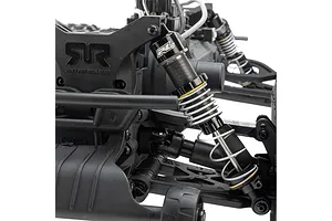 Close-up of a Pro-Line PowerStroke shock absorber installed on an RC vehicle chassis, featuring a black aluminium body and silver coil spring.