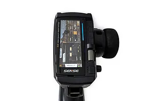 Top-down view of the Sense Innovations S10 10-channel RC transmitter showing the digital display screen and steering wheel.