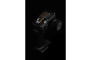 Sense Innovations S10 10-channel RC transmitter with a large digital screen and steering wheel, shown against a black background.