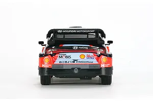 Rear view of the Carisma Hyundai i20N Rally1 RC car, showing the spoiler, sponsor decals, and exhaust detail against a white background.
