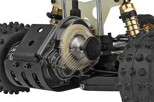 Close-up of the rear gear cover and motor area of a Team Associated RC10 Ultra Fox RC buggy, showing the clear plastic gear cover and gold shocks.