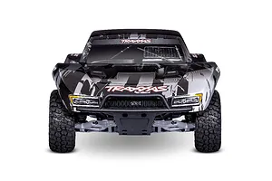 Front view of a Traxxas Slash 2WD RC short course truck with a black and silver graphic body, featuring a front bumper and off-road tires.