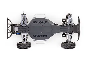 Top-down view of a Traxxas Slash 2WD RC truck chassis on a white background, showing the main tub, suspension arms, and rear bumper.