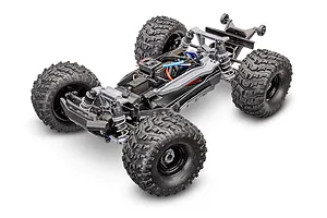 High-angle studio shot of a Traxxas Stampede 4X4 RC monster truck chassis without the body shell, showing the drivetrain, suspension, and motor.