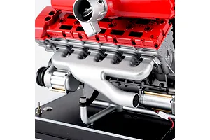 A close-up view of the Teching DM109 V12 engine model kit showing the red valve covers, silver exhaust manifold, and engine block on a display stand.
