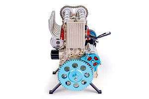 A front-facing view of the Teching DM113 four-cylinder engine model kit, featuring metallic gold, blue, and red components on a white background.