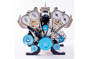 A detailed front-facing view of the Teching DM118 V8 engine model kit, showing metallic gears, chains, pulleys, and a black intake manifold.