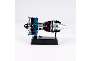 A side view of the Teching DM122 mini turbofan engine model kit mounted on a black display base against a white background.