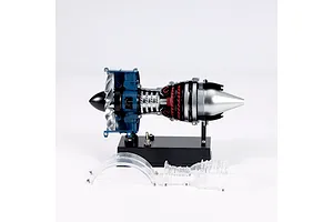 A Teching 1/20 scale metal turbofan engine model kit on a black display stand with two clear plastic casing pieces resting in front.