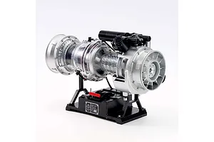 A Teching 1/10 scale T-700 turboshaft engine metal model kit displayed on a black stand against a white background.