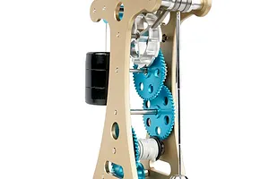 Close-up of the Teching DM335 Galileo Pendulum Clock metal model kit showing the internal gears, frame, and pendulum mechanism.