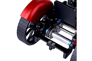Close-up of the internal mechanical assembly of a Teching DM616 tractor model, showing red fenders, black tracks, and metal drive shafts.