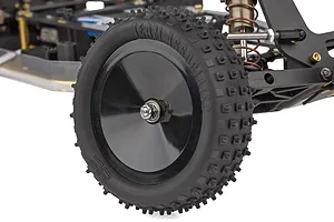 Close-up of the front wheel and suspension of a Team Associated RC10 buggy, showing a black dish wheel with knobby rubber tire.