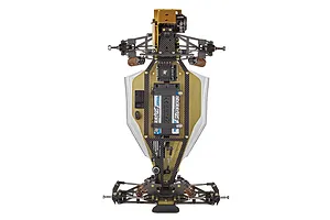 Top-down view of a Team Associated RC10 1991 Stealth Las Vegas Edition RC buggy chassis featuring a gold anodized aluminum tub and carbon fiber components.