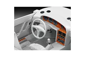 Close-up of the detailed interior of a 1/24 scale Bugatti EB 110 model car, showing the dashboard, steering wheel, and center console with wood-grain decals.