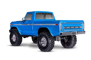 Rear three-quarter view of a bright blue Traxxas TRX-4 1979 Ford F-150 Ranger XLT RC rock crawler on a white background.