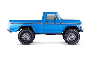Side profile view of a bright blue Traxxas TRX-4 1979 Ford F-150 Ranger XLT RC rock crawler on a white background.