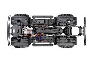 Top-down view of a Traxxas TRX-4 RC crawler chassis showing the motor, electronic speed controller, and drivetrain components on a white background.