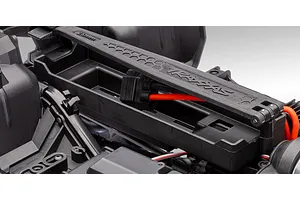 Close-up view of the battery tray and hold-down strap on a Traxxas TRX-4 RC chassis.