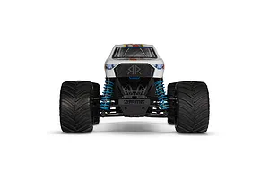 Front view of the ARRMA Freedom Flyer Grom 1/16 scale RC monster truck featuring a white body, blue coil-over shocks, and large black off-road tires.