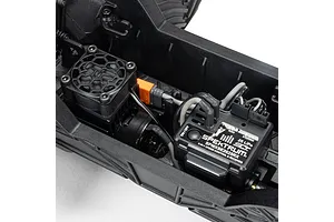 Close-up of the internal electronics of an ARRMA Grom RC vehicle, showing the Spektrum 2-in-1 ESC/receiver unit and motor cooling fan.
