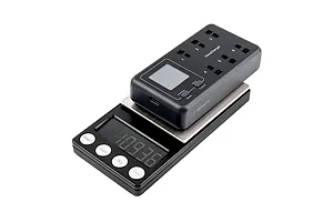 A BetaFPV HexaCharger 1S 6-port smart charger sitting on top of a digital weighing scale against a white background.